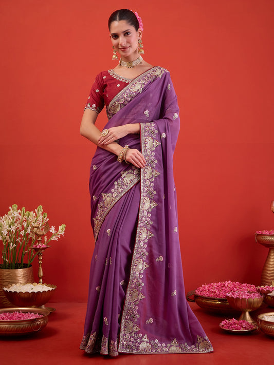 Woman wearing lavender georgette saree with ornamented surface design and maroon blouse