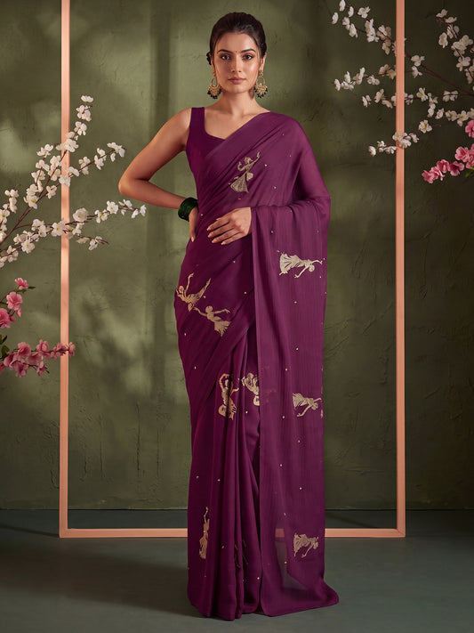 Woman wearing wine satin saree with embroidered motif work and wine blouse