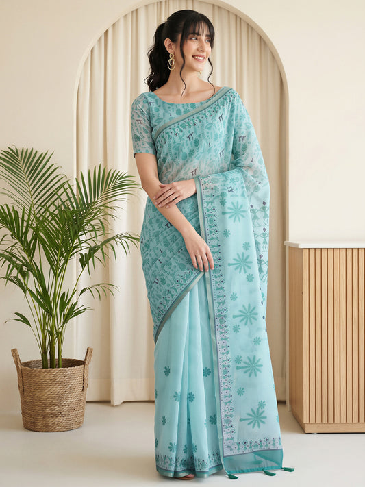 Woman wearing light blue cotton linen saree with warli folk-art figures and light blue blouse