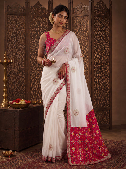 Woman wearing white viscose saree with zari butta (metallic motif) work and red blouse