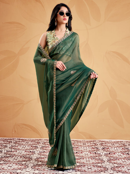 Woman wearing green tissue saree with ornamented surface design and light green blouse