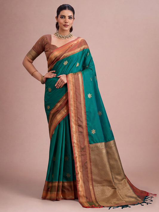 Woman wearing teal green tussar silk saree with traditional indian motif work and brown blouse