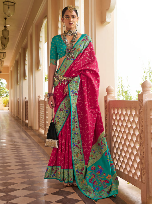 Woman wearing pink silk blend saree with all-over floral design and teal blue blouse