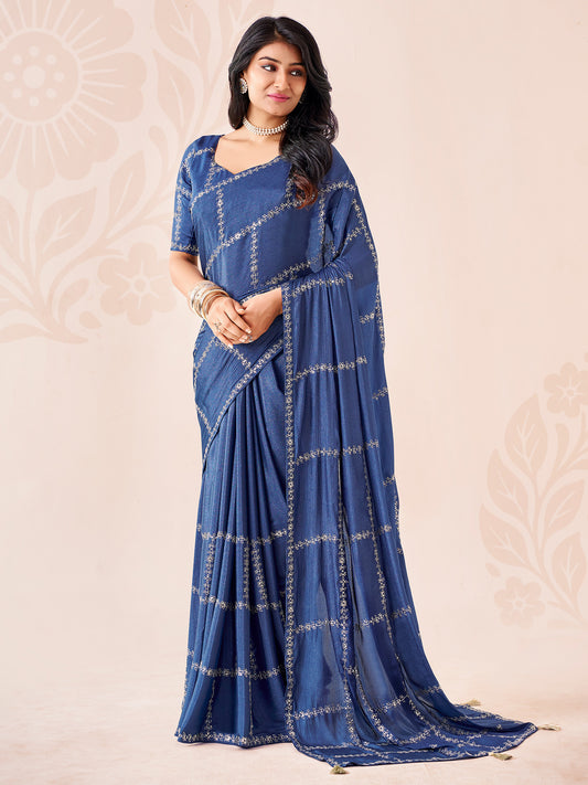 Woman wearing navy blue chiffon saree with ornamented surface design and navy blue blouse