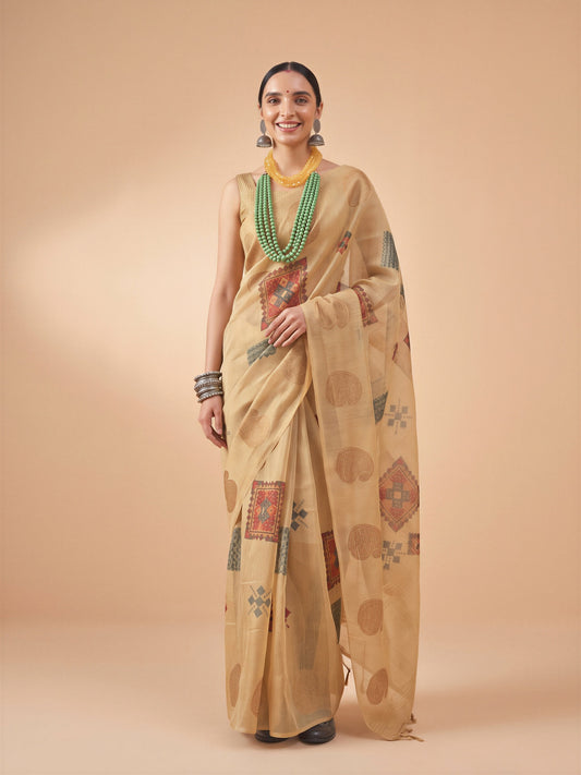 Woman wearing beige tissue saree with traditional indian motif work and beige blouse