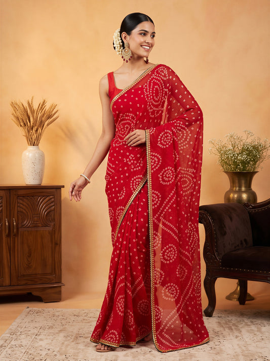 Woman wearing red georgette saree with bandhani tie-dye dot work and red blouse