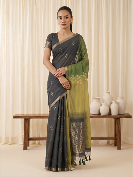 Woman wearing green viscose silk saree with traditional indian motif work and black blouse