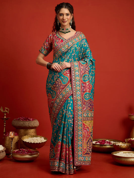Woman wearing aqua blue silk blend saree with traditional indian motif work and pink blouse