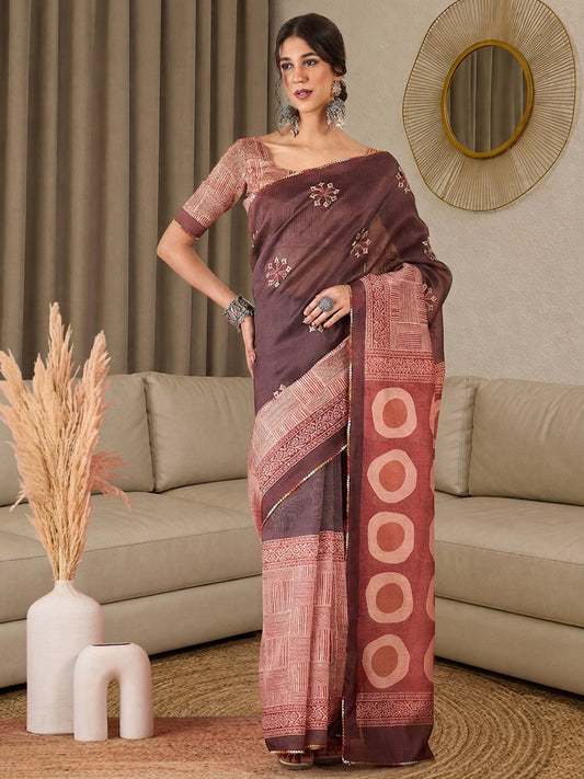Woman wearing light brown silk blend saree with all-over floral design and peach blouse