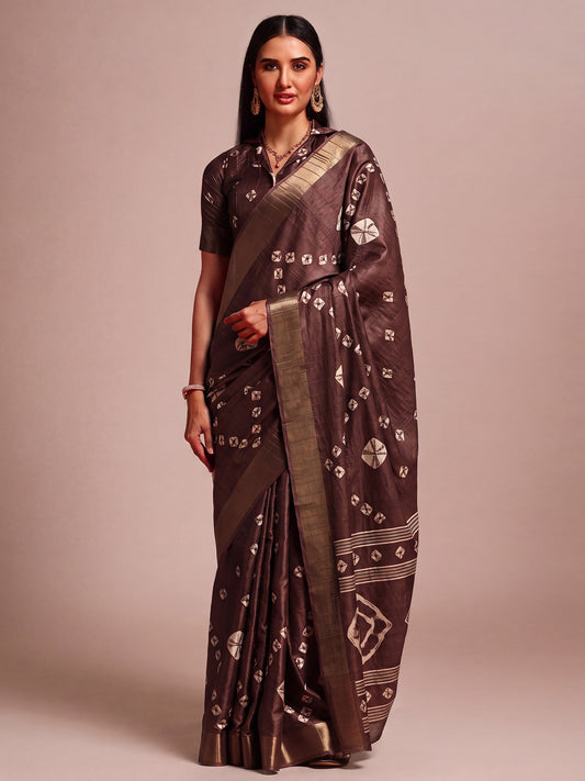 Woman wearing dark brown silk blend saree with traditional indian motif work and dark brown blouse