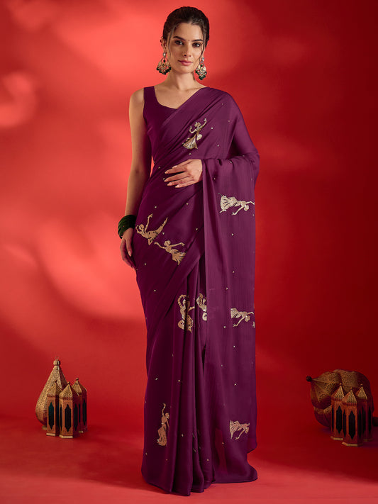 Woman wearing wine satin saree with embroidered motif work and wine blouse