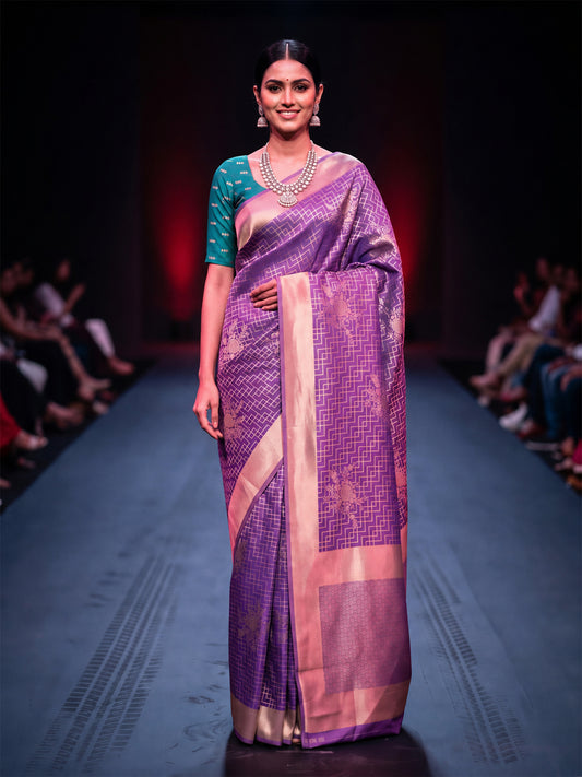 Woman wearing purple silk blend saree with zari butta (metallic motif) work and teal green blouse