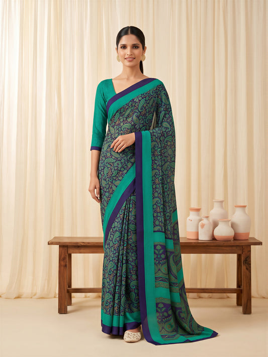 Woman wearing teal green crepe saree with bagh block-print motif work and teal green blouse