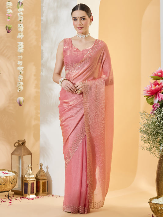 Woman wearing peach satin saree with clean solid-tone finish and peach blouse