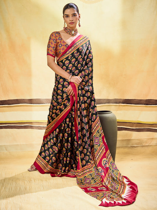Woman wearing black satin saree with ajrak block-print motif work and rust blouse