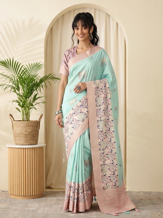 Woman wearing turquoise silk blend saree with traditional indian motif work and pink blouse