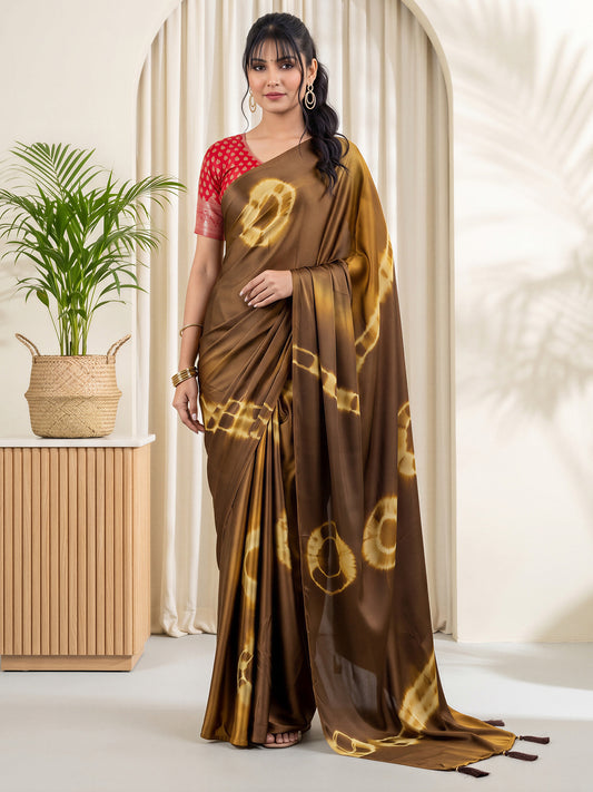 Woman wearing brown satin silk saree with tie-and-dye resist pattern and red blouse