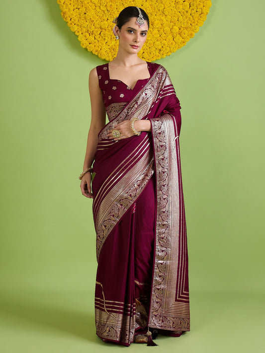 Woman wearing wine silk blend saree with zari butta (metallic motif) work and wine blouse