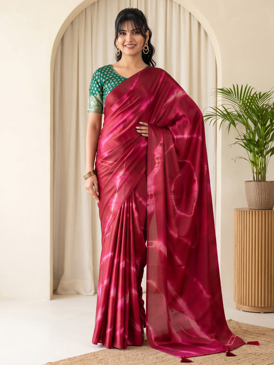 Woman wearing maroon satin silk saree with tie-and-dye resist pattern and green blouse