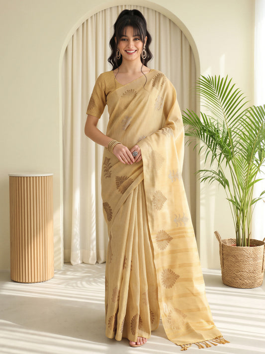 Woman wearing cream linen saree with traditional indian motif work and cream blouse