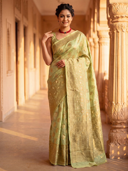 Woman wearing light green silk blend saree with zari butta (metallic motif) work and light green blouse