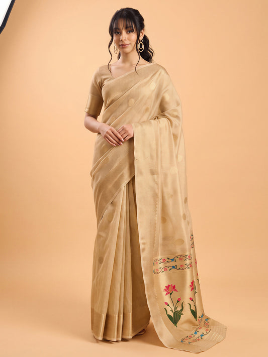 Woman wearing cream tissue saree with zari butta (metallic motif) work and cream blouse