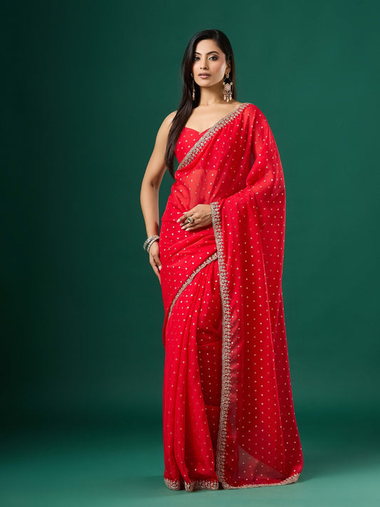 Woman wearing red georgette saree with ornamented surface design and red blouse