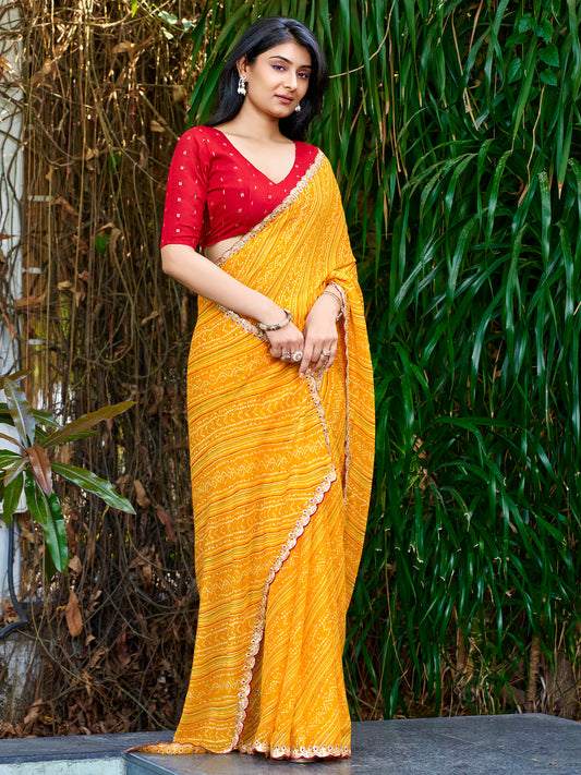 Woman wearing yellow georgette saree with bandhani tie-dye dot work and red blouse