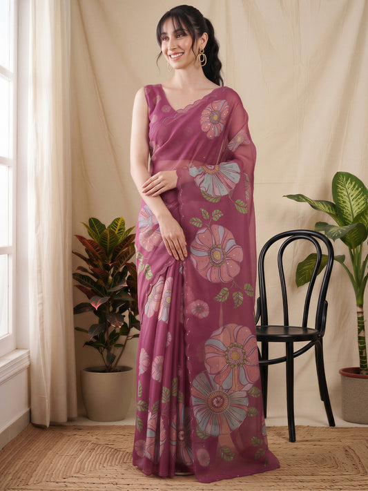 Woman wearing magenta organza saree with all-over floral design and magenta blouse