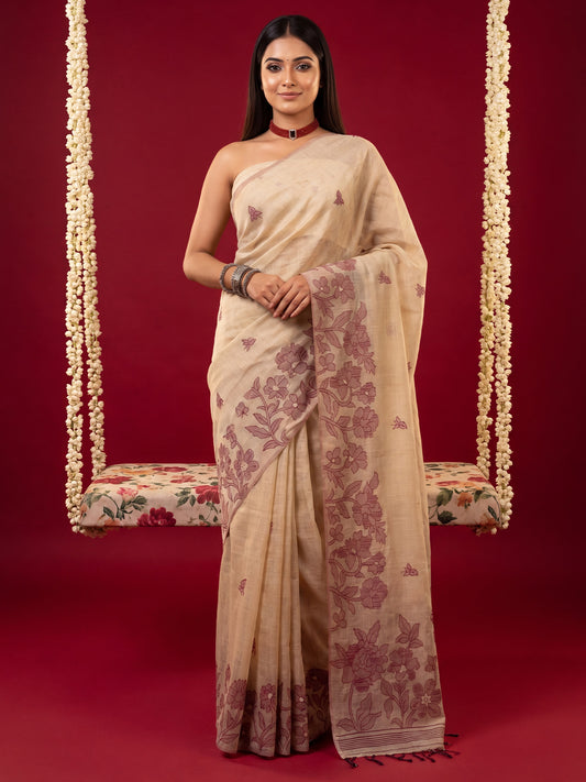 Woman wearing cream chanderi cotton saree with all-over floral design and cream blouse