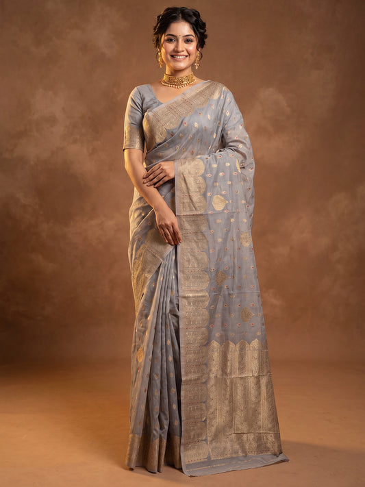 Woman wearing grey silk blend saree with zari butta (metallic motif) work and grey blouse