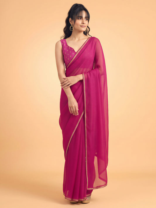 Woman wearing pink silk saree with clean solid-tone finish and pink blouse