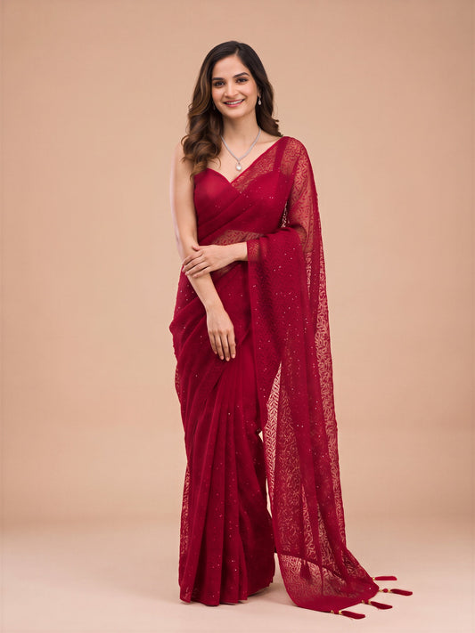 Woman wearing maroon net saree with embroidered motif work and maroon blouse