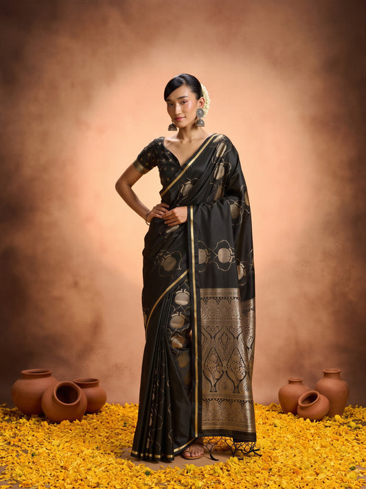 Woman wearing black satin saree with zari butta (metallic motif) work and black blouse