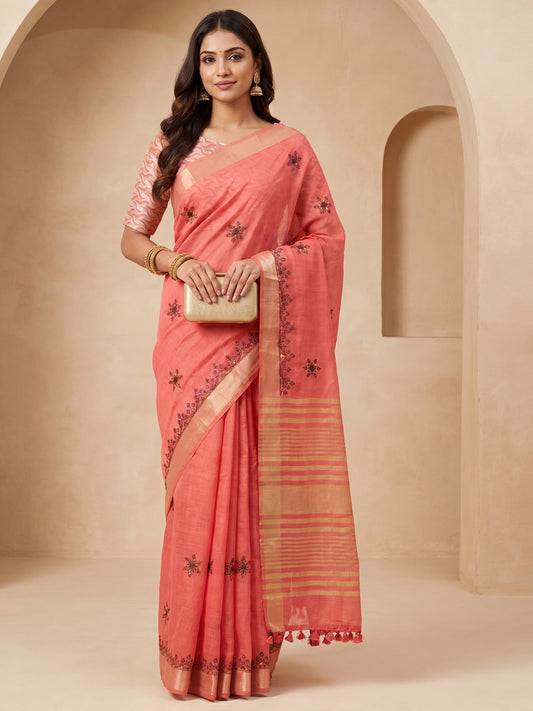 Woman wearing peach cotton linen saree with embroidered motif work and peach blouse