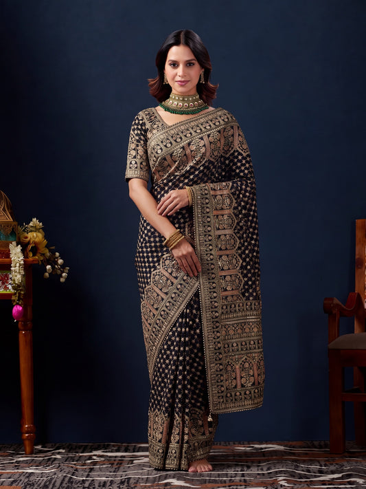 Woman wearing black silk blend saree with traditional indian motif work and black blouse