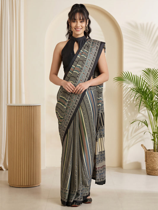 Woman wearing grey satin saree with traditional indian motif work and black blouse