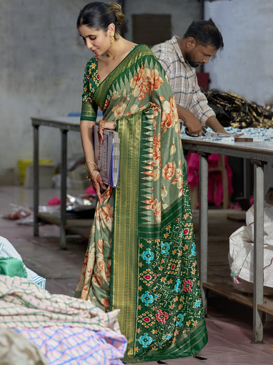 Woman wearing sea green tussar silk saree with ikat resist-dyed pattern and green blouse