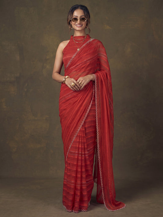 Woman wearing red georgette saree with striped pattern design and red blouse