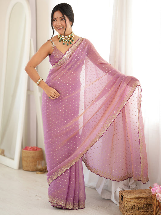 Woman wearing pink silk blend saree with ornamented surface design and pink blouse