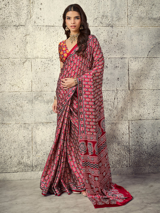 Woman wearing maroon satin saree with ajrak block-print motif work and rust blouse