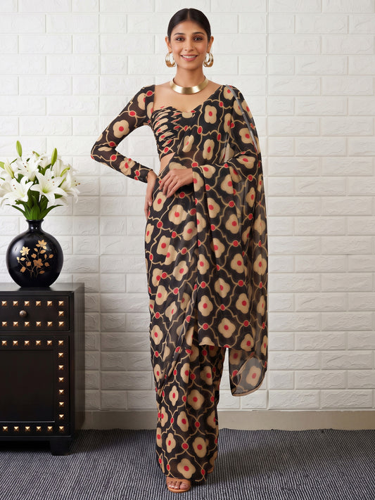 Woman wearing black satin saree with all-over floral design and black blouse