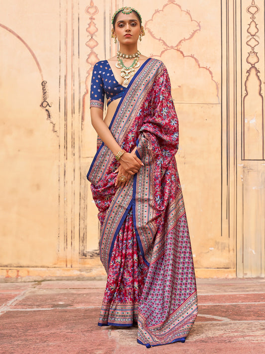 Woman wearing magenta silk blend saree with kalamkari narrative motif work and navy blue blouse
