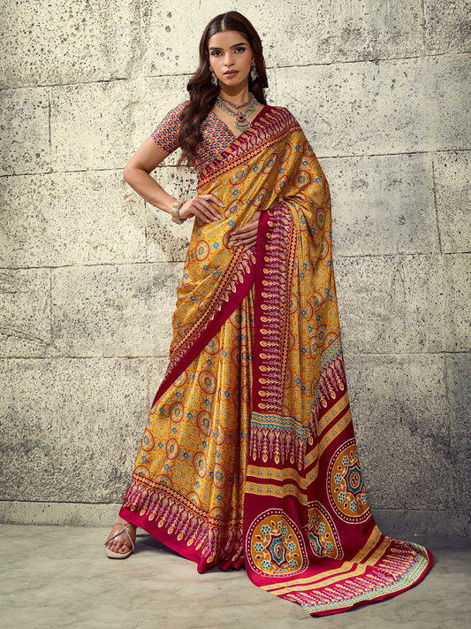 Woman wearing mustard satin saree with ajrak block-print motif work and maroon blouse