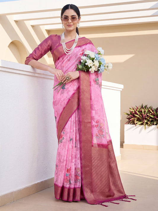 Woman wearing pink organza saree with traditional indian motif work and magenta blouse