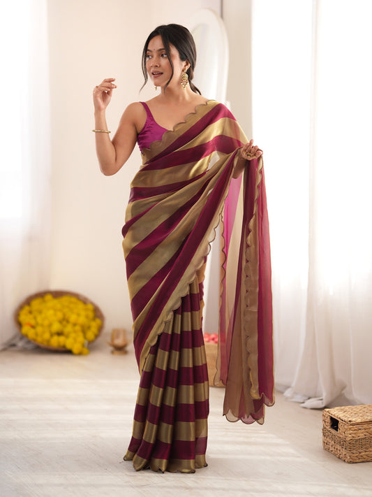 Woman wearing wine satin saree with striped pattern design and wine blouse