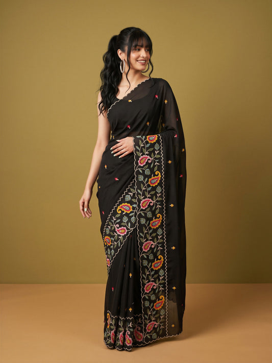 Woman wearing black georgette saree with embroidered motif work and black blouse