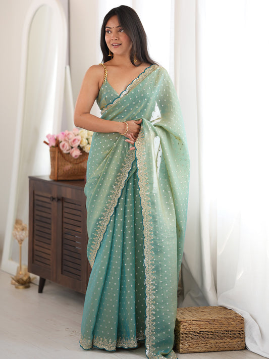 Woman wearing light blue silk blend saree with ornamented surface design and light blue blouse