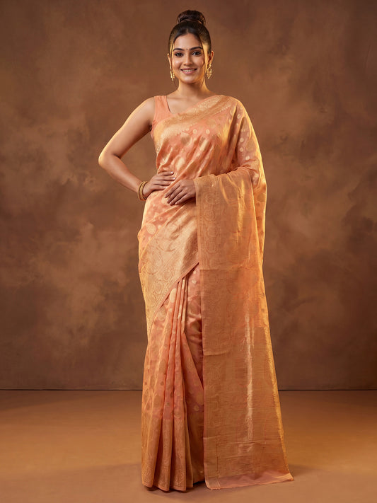 Woman wearing orange silk blend saree with zari butta (metallic motif) work and orange blouse