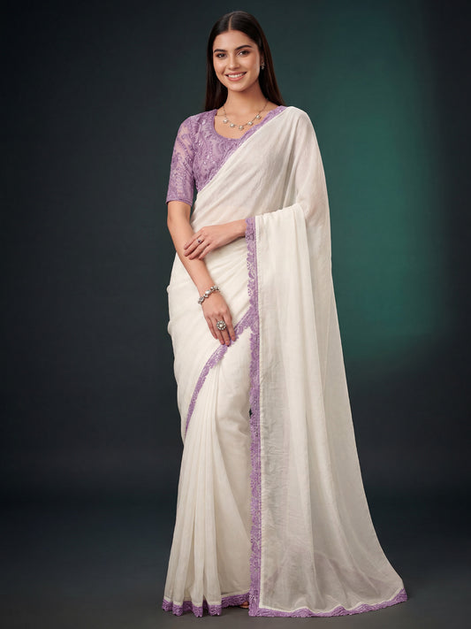 Woman wearing white georgette saree with ornamented surface design and lavender blouse